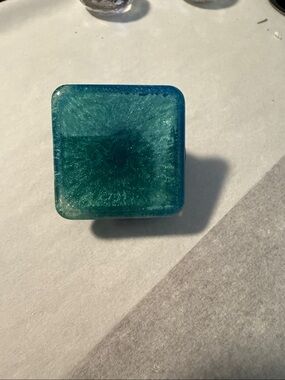 Blue-green or Teal Square-Shaped  “Pop Socket-like” Phone Grip